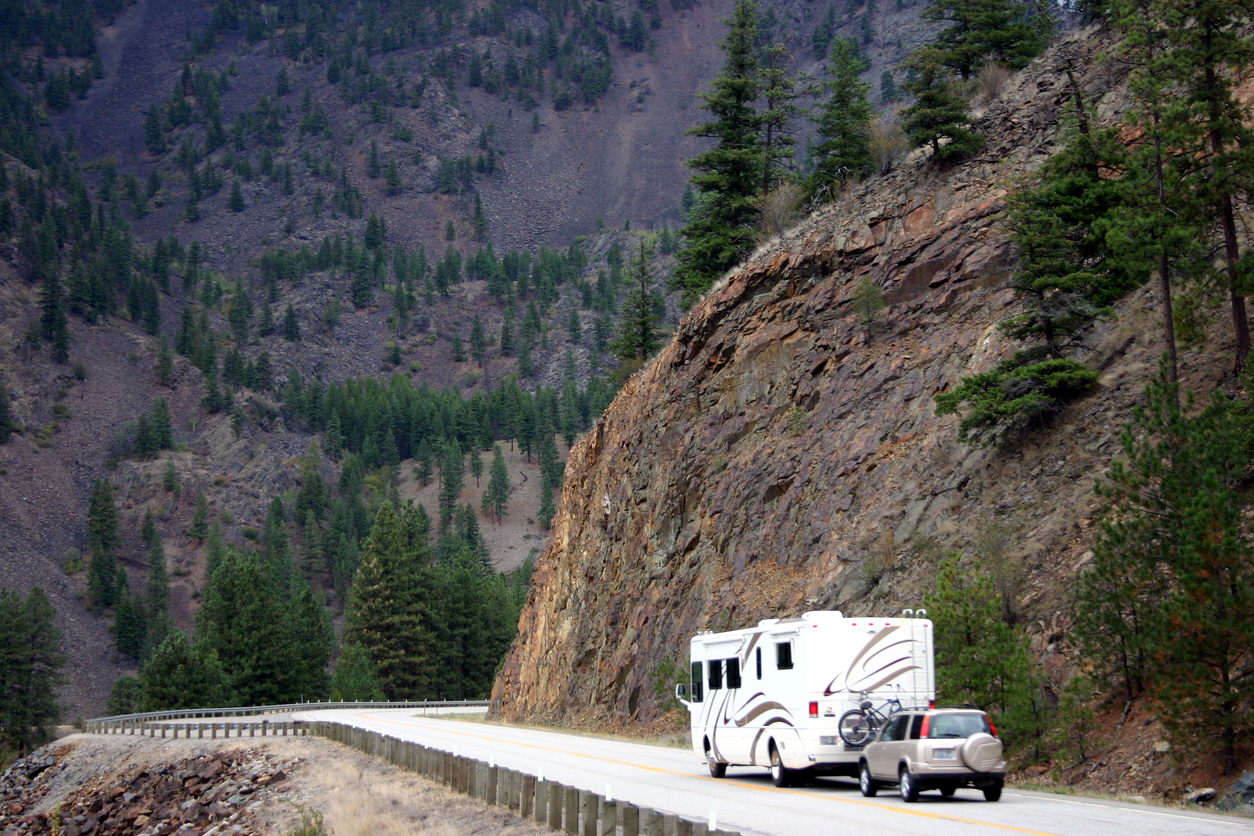 RV motorhome followed by SUV on a mountain highway