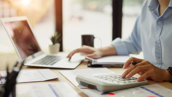 Businessman calculating finances at office desk. Concepts of finance management