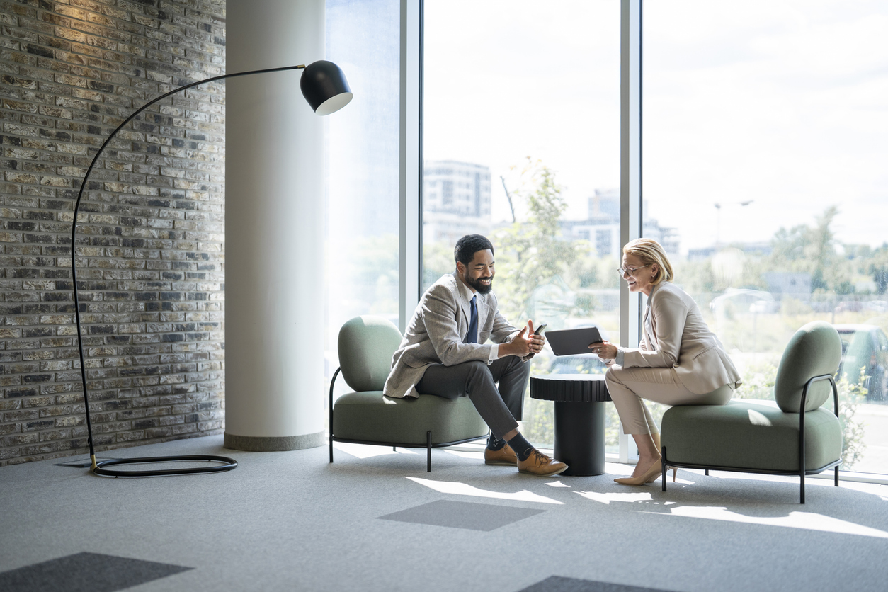 Business people discussing using digital tablet and smartphone in modern office